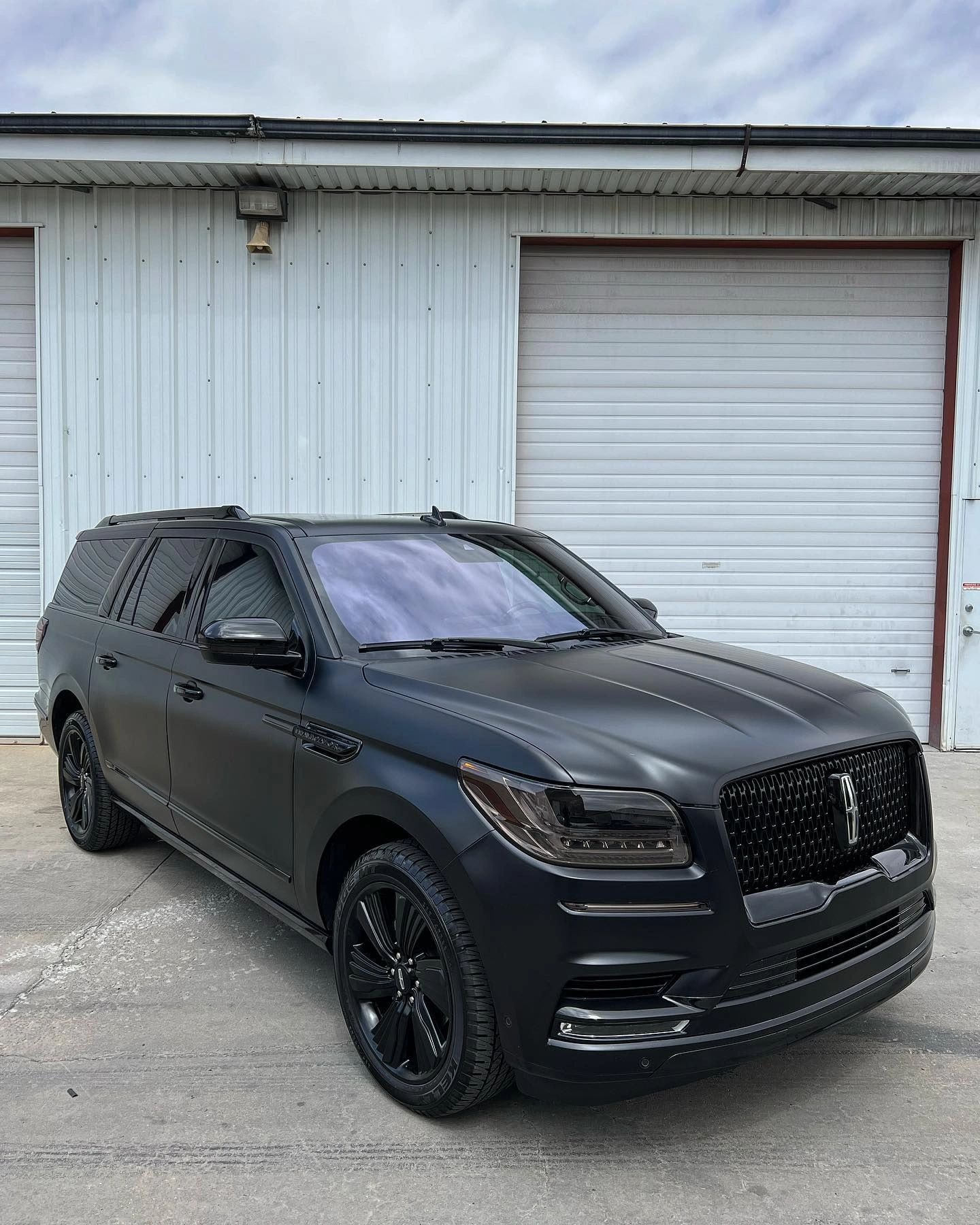 Matte black vehicle wrap installation at Tint Citi Utah Salt Lake City automotive studio