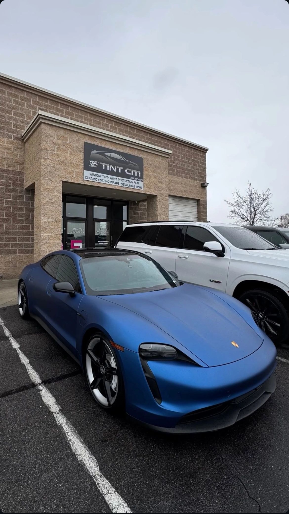 Blue Porsche SUV with professional window tint installed at Tint Citi Utah, Salt Lake City